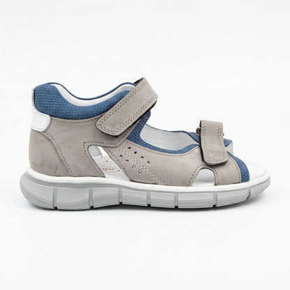Grooved grey traction outsole on boys low-top orthopaedic sandals showing arch and heel guidance contours