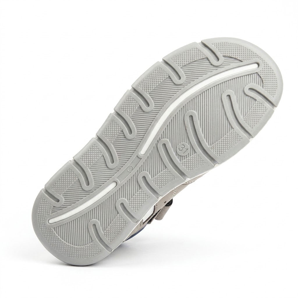 Grooved non-slip grey outsole on boys low-top orthopaedic sandals with arch guidance contours and traction pads