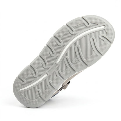 Grooved non-slip grey outsole on boys low-top orthopaedic sandals with arch guidance contours and traction pads