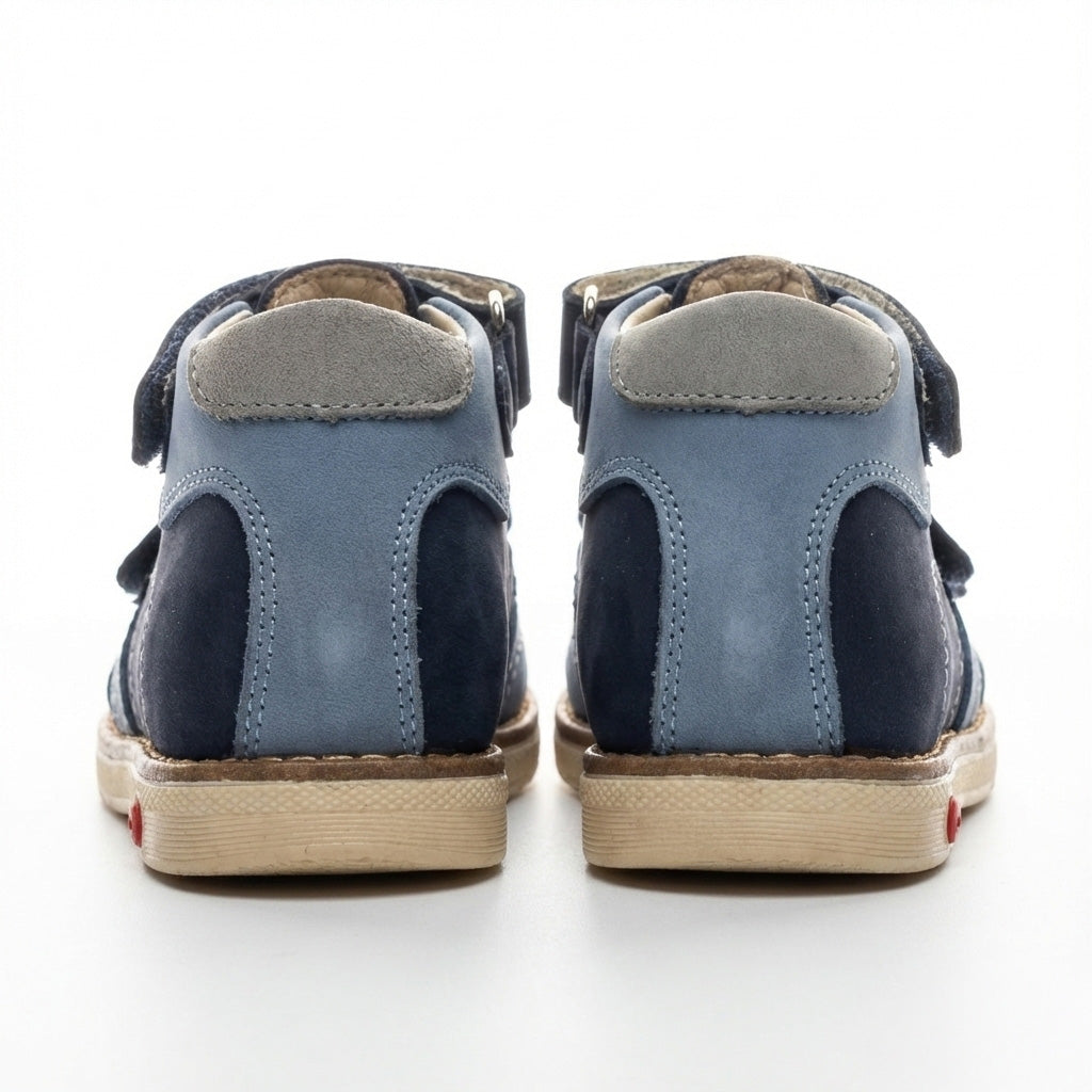 Children’s orthopedic sandals in blue with Velcro straps, arch and ankle support, Thomas heels and Ortho Shoes branding.