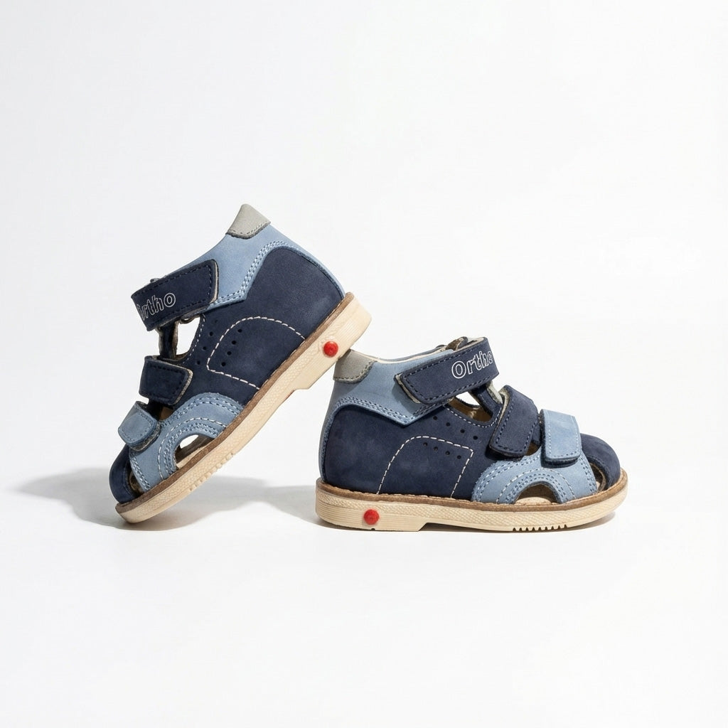Children’s orthopedic sandals in blue with Velcro straps, arch and ankle support, Thomas heels and Ortho Shoes branding.