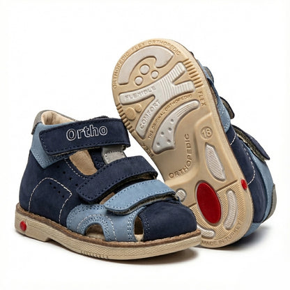 Children’s orthopedic sandals in blue with Velcro straps, arch and ankle support, Thomas heels and Ortho Shoes branding.