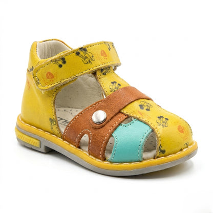 Children’s yellow orthopedic sandal with Velcro strap, brown and turquoise accents, supportive grey sole, featuring arch and ankle support, and playful printed details by Minimen.