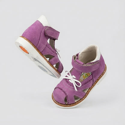 Girls’ orthopedic sandals in bright purple with Velcro straps, ankle  and arch support, and Thomas heels for early walkers by Woopy.