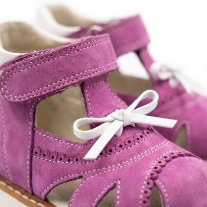 Girls’ orthopedic sandals in bright purple with Velcro straps, ankle  and arch support, and Thomas heels for early walkers by Woopy.