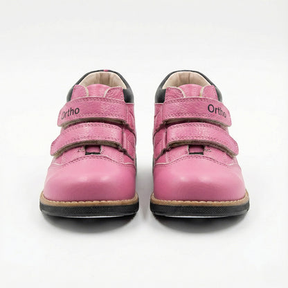 Girls’ orthopedic boots in pink with Velcro closure, arch and ankle support, Thomas heels, and black sole by Ortho Shoes.