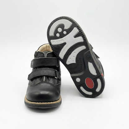 Supportive black orthopedic half-boots for kids with Velcro closure, arch and ankle support, Thomas heels, rugged sole, and dust-resistant design by Ortho Shoes.