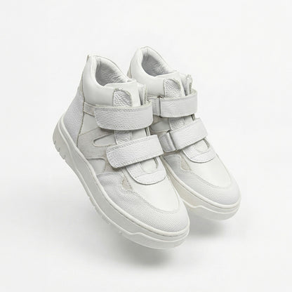 Children’s white orthopedic high-top sneakers with Velcro straps, ankle support, durable sole by Ortho Shoes.