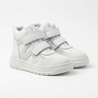 Children’s white orthopedic high-top sneakers with Velcro straps, ankle support, durable sole by Ortho Shoes.