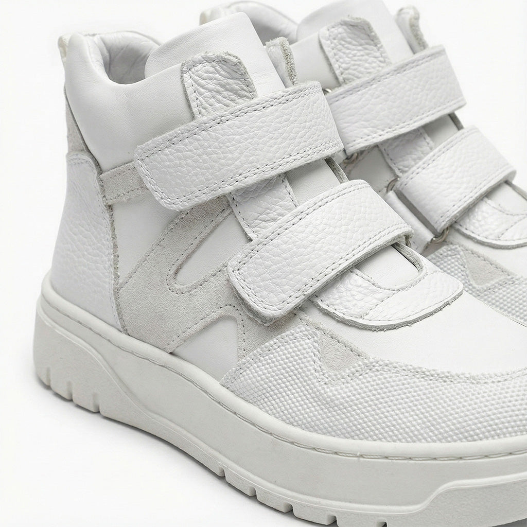 Children’s orthopedic high-top sneakers in white with Velcro closure by Ortho Shoes.