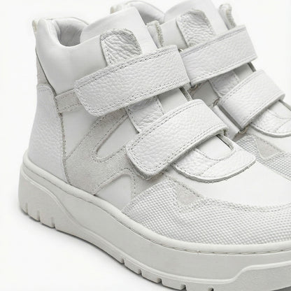 Children’s orthopedic high-top sneakers in white with Velcro closure by Ortho Shoes.