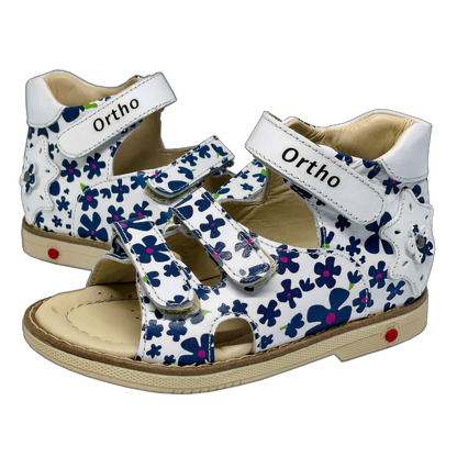 Photo of orthopedic sandals for girls in white color adorned with navy flowers, featuring arch and ankle support for comfort and stability.