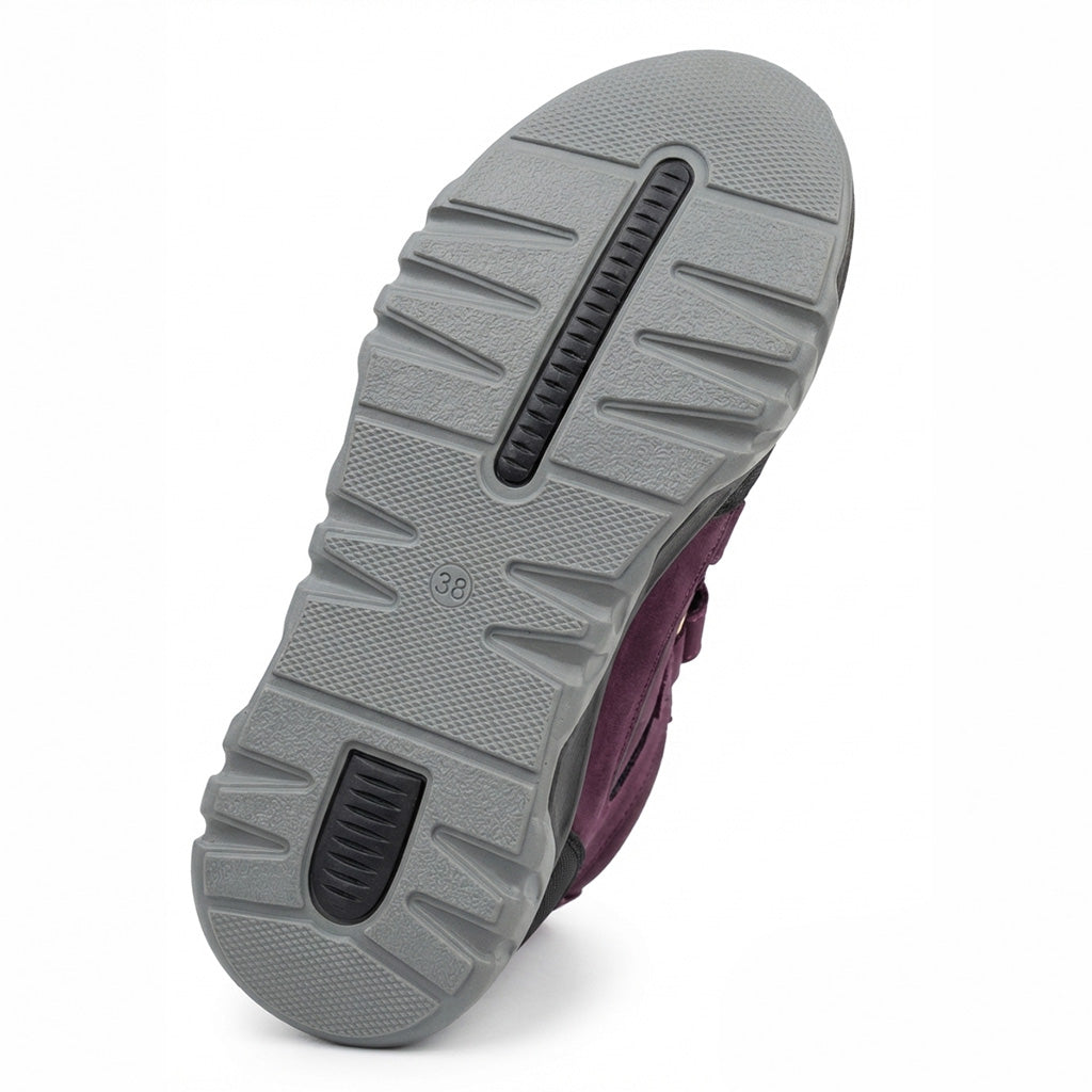 Sole design of teen girls’ orthopedic boots in dark purple and black with Velcro straps with arch and ankle support by Ortho.