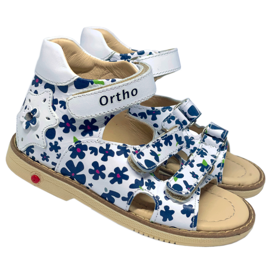 Photo of orthopedic sandals for girls in white color adorned with navy flowers, featuring arch and ankle support for comfort and stability.